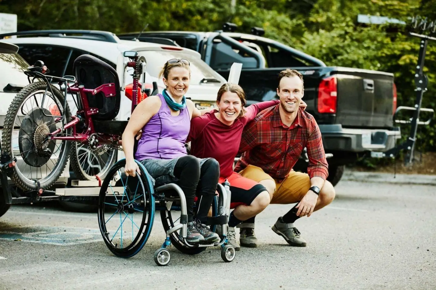 Group with a support worker beside an accessible van