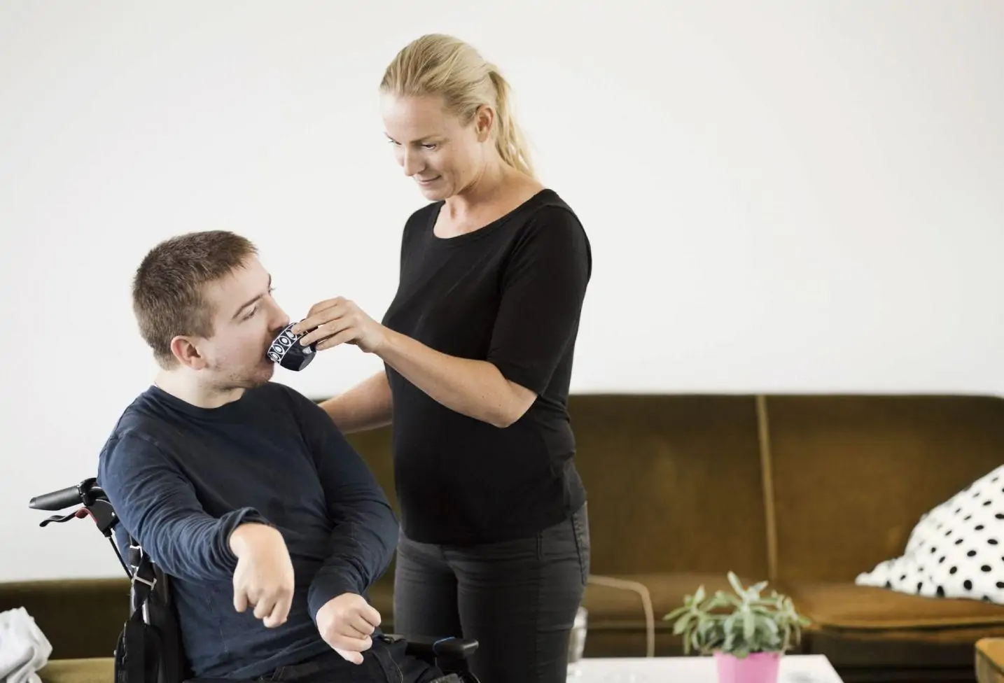Support worker helping a young child at home